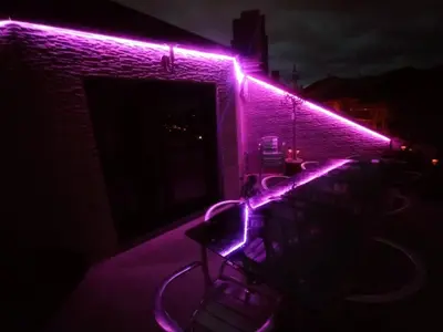 a room with purple lights on a brick wall at Duplex grandes cristaleras impresionantes vistas in Ourense