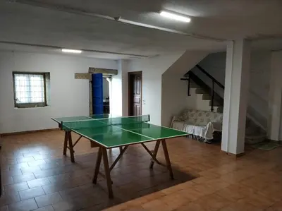 a ping pong table in the middle of a room at PRECIOSA CASA DE 4 HABITACIONES EN PLENO CORAZÓN DEL CAMINO DE SANTIAGO! in Palas de Rei