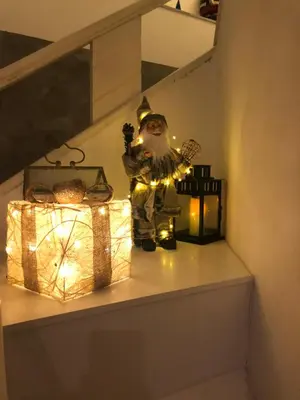 a santa claus figurine on a staircase with lights at Hotel tres estrellas Casa Maribona Gela in El Puente