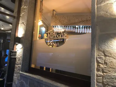 a window of a bar with a sign on the wall at Hotel tres estrellas Casa Maribona Gela in El Puente