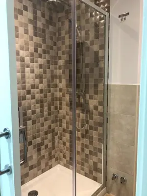 a bathroom with a shower with a glass door at Hotel tres estrellas Casa Maribona Gela in El Puente