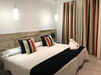 a bedroom with a large bed with pillows at Hotel tres estrellas Casa Maribona Gela in El Puente
