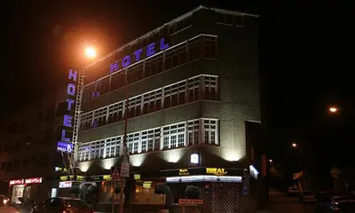 a building with a hotel sign on it at night at Hotel Brial in Perillo