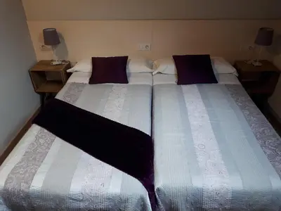 two beds sitting next to each other in a bedroom at Ultreia in Portomarin