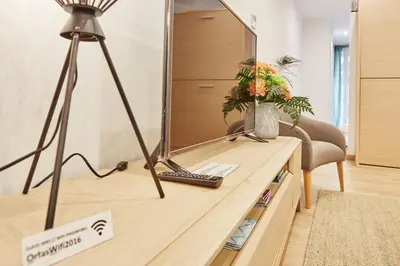 a desk with a mirror and a lamp on it at Apartamentos Orfas in Santiago de Compostela