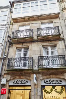 a building with balconies on the side of it at Apartamentos Orfas in Santiago de Compostela