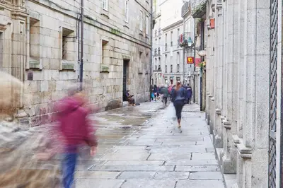 a group of people walking down a street at Apartamentos Orfas in Santiago de Compostela
