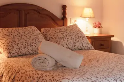 a bed with two pillows and a towel on it at 
