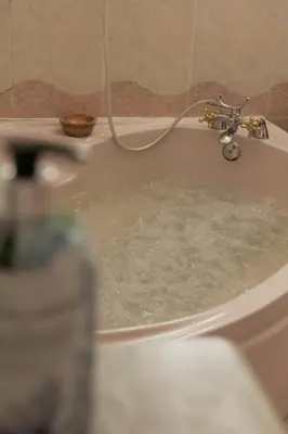 a bath tub filled with water with a faucet at 