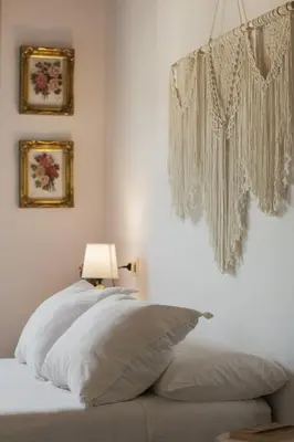 a bedroom with a bed with white pillows and a lamp at 