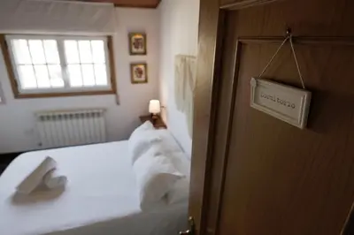 a bedroom with a bed with white pillows and a window at 