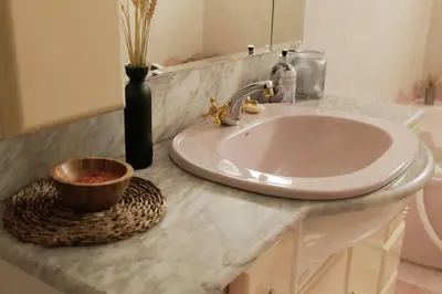 a bathroom sink with a bowl on a counter at 