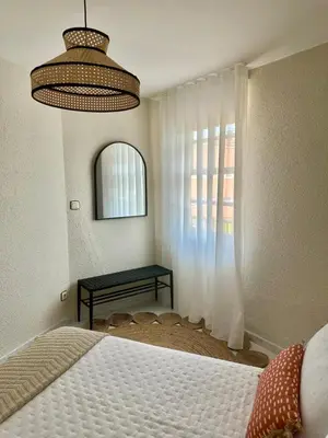 a bedroom with a bed and a window at Apartamentos Sarga Sentirgalicia in Cabañas