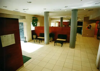 a lobby with columns and benches in a building at Apartamentos Sarga Sentirgalicia in Cabañas