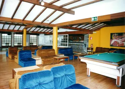 a pool room with couches and a pool table at Apartamentos Sarga Sentirgalicia in Cabañas