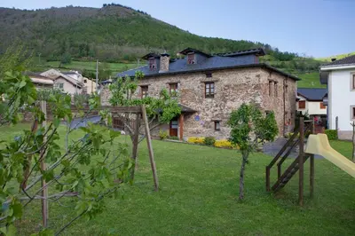 a large stone building in the middle of a yard at Casa Ponce in Posada de Rengos