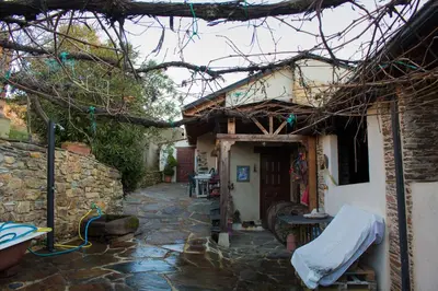 a stone walkway leading to a house with a building at CASA CASTAÑÉ in Puente de Domingo Flórez