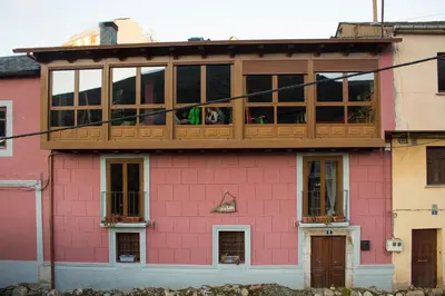 a pink house with a deck on top of it at CASA CASTAÑÉ in Puente de Domingo Flórez