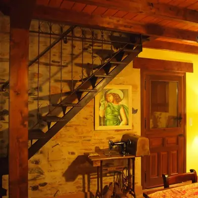 a staircase in a room with a painting on the wall at CASA CASTAÑÉ in Puente de Domingo Flórez