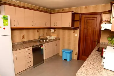 a small kitchen with a sink and a refrigerator at Piso Ourense Bonito y Termal in Ourense