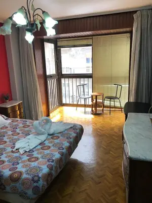 a bedroom with a bed with a person laying on it at Piso Ourense Bonito y Termal in Ourense
