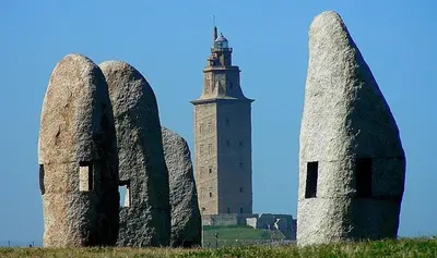 a building with a clock tower and some stone statues at Stone Cottage FINISTERRE in Curtis