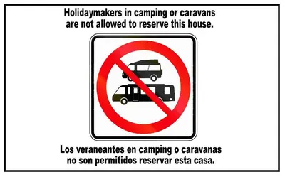 a sign with a no parking sign with a truck in it at Stone Cottage FINISTERRE in Curtis
