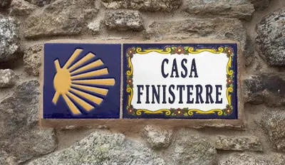 a sign on the side of a stone wall at Stone Cottage FINISTERRE in Curtis