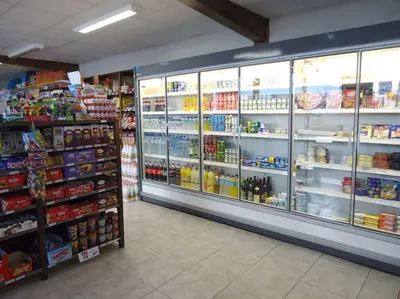 a store aisle of a grocery store with shelves of food at Albergue Restaurante Casa Herminia in El Campiello