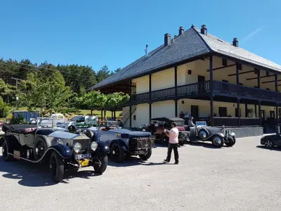 a group of cars parked in front of a building at Complejo O Piñeiral A Fonsagrada in Fonsagrada