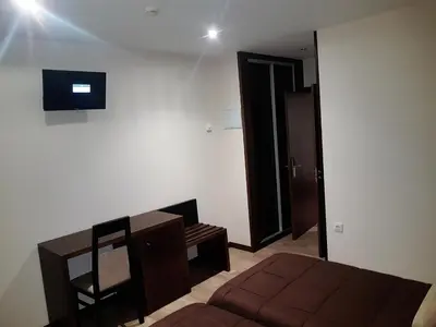 a bedroom with a bed and a table and a chair at Complejo O Piñeiral A Fonsagrada in Fonsagrada