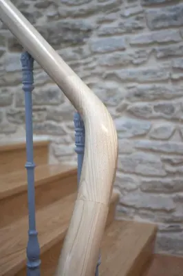 a wooden baseball bat on the rail of some stairs at Catedral Site by Como en Casa in Santiago de Compostela