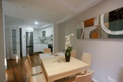 a kitchen and dining room with a table and chairs at Catedral Site by Como en Casa in Santiago de Compostela