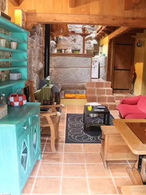 a living room with a couch and a table at Bodega rural tipo loft in Ourense
