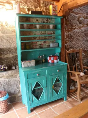 a turquoise cabinet with a blue island in a room at Bodega rural tipo loft in Ourense