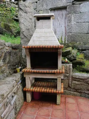 a brick oven sitting on top of a patio at Bodega rural tipo loft in Ourense