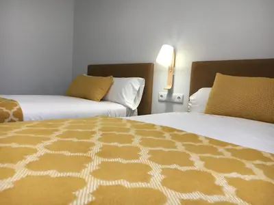 a hotel room with two beds at Lux Apartamentos Rosalia in Santiago de Compostela