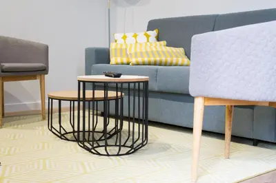 a living room with two tables and a couch at Lux Apartamentos Rosalia in Santiago de Compostela