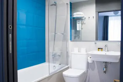 a bathroom with a toilet and a sink and a shower at Lux Apartamentos Rosalia in Santiago de Compostela