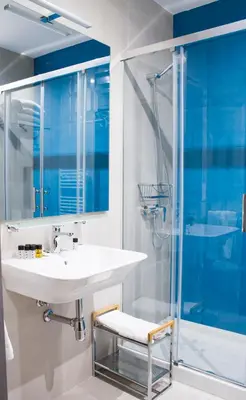 a bathroom with a sink and a shower at Lux Apartamentos Rosalia in Santiago de Compostela