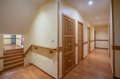 an empty hallway with stairs and an open door at Hotel Restaurante Cazador in Pereiro