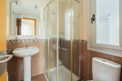a bathroom with a shower and a sink and a toilet at Hotel Restaurante Cazador in Pereiro