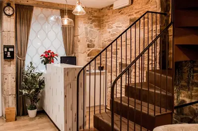 a staircase in a room with a stone wall at Casa da Balconada in Santiago de Compostela
