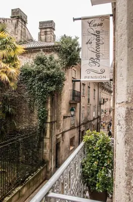 a balcony of a building with a sign for a restaurant at Casa da Balconada in Santiago de Compostela