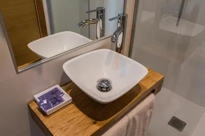 a bathroom with a white sink and a mirror at Casa da Balconada in Santiago de Compostela