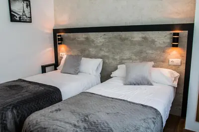 two beds sitting next to each other in a room at Casa da Balconada in Santiago de Compostela