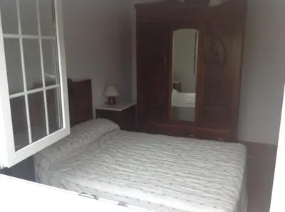 a bedroom with a bed and a large mirror at Casa As Pedreiras in Barreiros