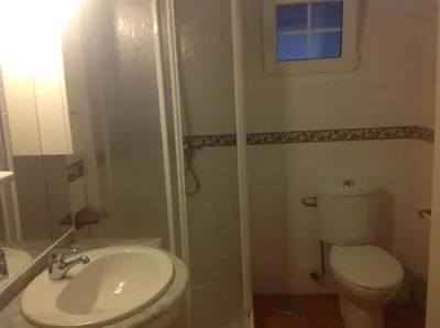 a bathroom with a toilet and a shower and a sink at Casa As Pedreiras in Barreiros