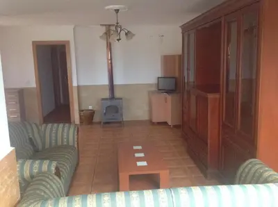 a living room with a couch and a table at Casa As Pedreiras in Barreiros