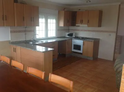 a kitchen with a sink and a stove top oven at Casa As Pedreiras in Barreiros